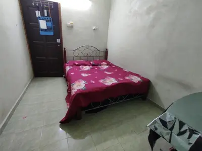 a small bedroom with a bed with a red blanket at Penang Green Homestay Ground Floor in Permatang Pauh