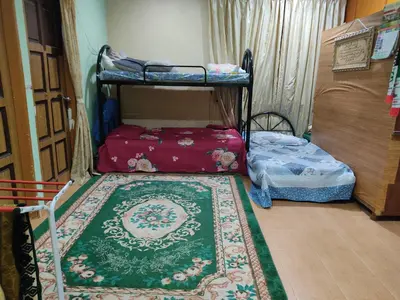 a room with two bunk beds and a rug at Penang Green Homestay Ground Floor in Permatang Pauh