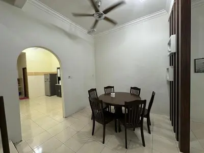 a dining room with a table and chairs at Joyhome Homestay in Kampong Lumut Kiri