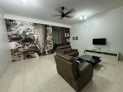 a living room with two couches and a flat screen tv at Joyhome Homestay in Kampong Lumut Kiri