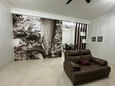 a living room with a couch in front of a painting at Joyhome Homestay in Kampong Lumut Kiri