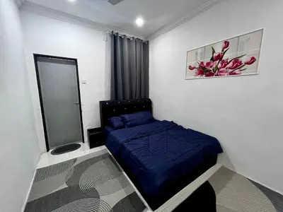 a small bedroom with a blue bed and a window at DH Homestay in Sungai Petani