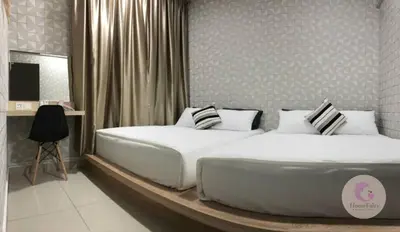a bedroom with a large white bed and a desk at The Majestic Condo Ipoh Home Fairy 5 in Ipoh