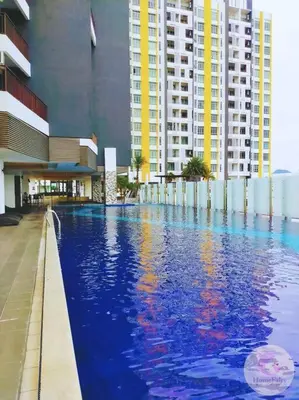 a large swimming pool in a building with tall buildings at The Majestic Condo Ipoh Home Fairy 5 in Ipoh