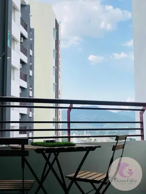 a table and chair on a balcony with a view of the ocean at The Majestic Condo Ipoh Home Fairy 5 in Ipoh