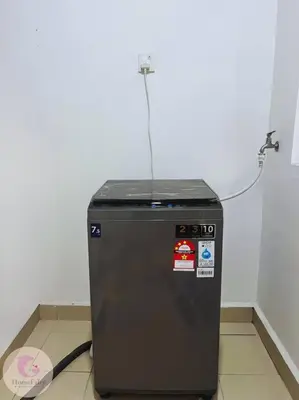 a black refrigerator sitting in a corner of a room at The Majestic Condo Ipoh Home Fairy 5 in Ipoh