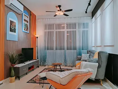 a living room with a couch and a ceiling fan at A boutique Warm falim home in Kampong Pasir Puteh