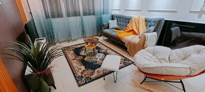 a living room with two chairs and a couch at A boutique Warm falim home in Kampong Pasir Puteh