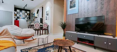 a living room with a flat screen tv on a cabinet at A boutique Warm falim home in Kampong Pasir Puteh