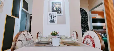 a table with bowls and plates on top of it at A boutique Warm falim home in Kampong Pasir Puteh