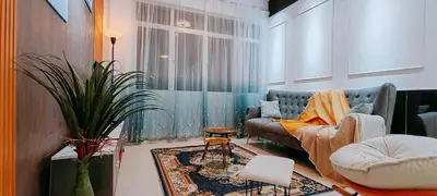 a living room with a couch and a table at A boutique Warm falim home in Kampong Pasir Puteh