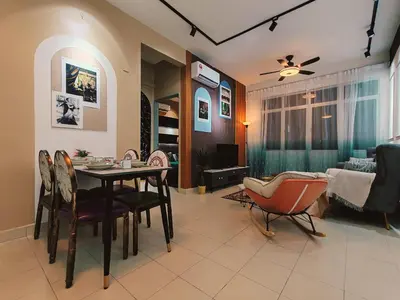 a living room with a dining room table and chairs at A boutique Warm falim home in Kampong Pasir Puteh