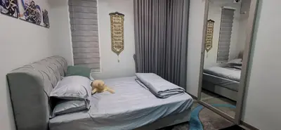 a dog laying on a bed in a bedroom at Teratak Dusun NadzYan in Bukit Selambau