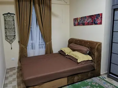 a small bed in a room with a window at Teratak Dusun NadzYan in Bukit Selambau