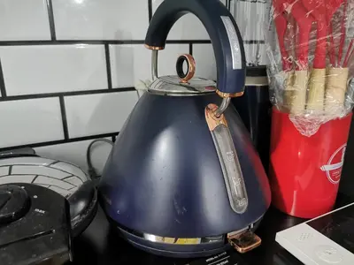 a blue tea kettle sitting on top of a counter at Teratak Dusun NadzYan in Bukit Selambau