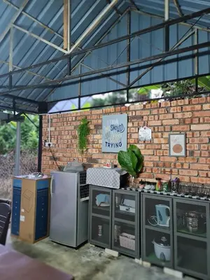 a food stand in a brick building with a brick wall at Zue Rra Hidden Retreat in Kampong Kuala Chegar