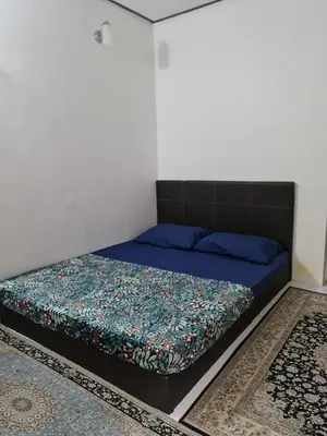 a bed in a room with a blue mattress at Zue Rra Hidden Retreat in Kampong Kuala Chegar
