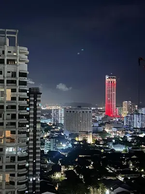 a city at night with a red lit up building at City View & Sea View Mansion One Gleneagles Gurney Komtar George Town by Cozy Cottage Haven in George Town