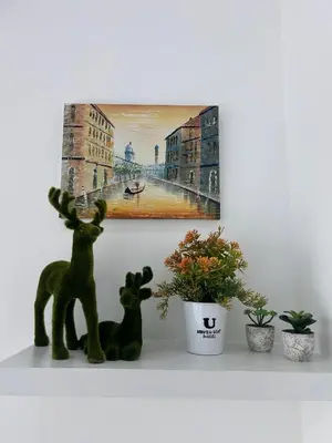 two deer on a shelf with plants and a painting at City View & Sea View Mansion One Gleneagles Gurney Komtar George Town by Cozy Cottage Haven in George Town