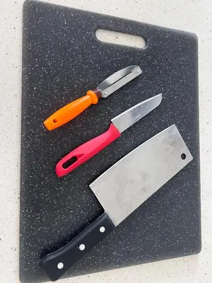 a pair of scissors and a knife on a cutting board at City View & Sea View Mansion One Gleneagles Gurney Komtar George Town by Cozy Cottage Haven in George Town