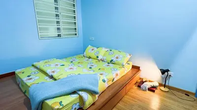 a childs bedroom with a bed with a yellow comforter at IPOH Sky Garden Residences, 31200 Chemor Ipoh in Chemor