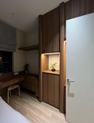 a room with a bed and a desk and a door at Sky High Stuning Penang Bridge & City Views 3BR in Jelutong