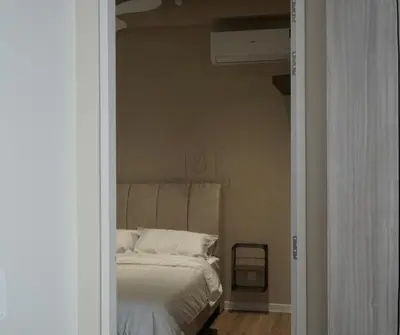 a bed with white sheets and pillows in a bedroom at Sky High Stuning Penang Bridge & City Views 3BR in Jelutong