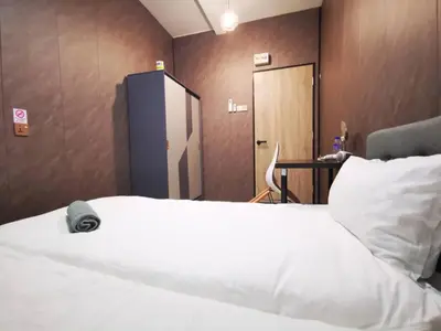 a bedroom with a white bed and a wooden wall at 1Pax-2Pax Single Room in Bukit Mertajam Alma Impian in Juru