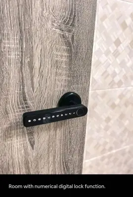 a black remote control sitting on top of a shower door at 1Pax Single Room in Bukit Mertajam Alma Impian in Juru