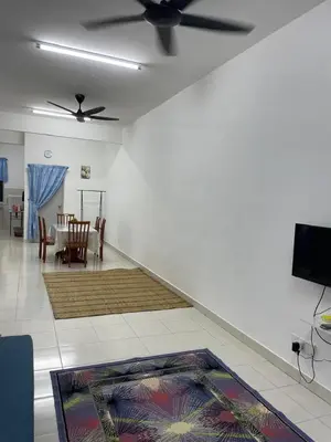 a living room with a ceiling fan and a rug at Amad Homestay in Kuala Lipis