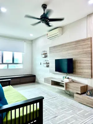 a living room with a ceiling fan and a television at Arena guesthouse in Bayan Lepas