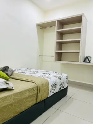 a bedroom with a bed and a book shelf at Arena guesthouse in Bayan Lepas