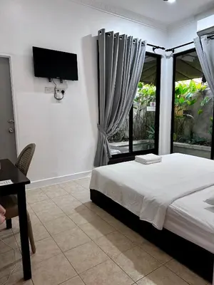 a bedroom with a bed and a desk and a television at Ardour Lodge 