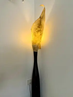 a vase with a leaf on top of a lamp at Ardour Lodge 