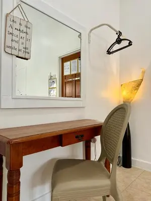 a desk with a mirror and a chair at Ardour Lodge 