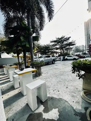 a row of white benches in a parking lot at Ardour Lodge 