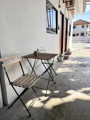 a wooden table and a bench next to a building at Ardour Lodge 