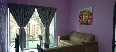 a living room with a couch and a large window at Oh Hanna homestay in Brinchang