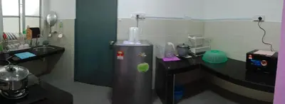 a bathroom with a sink and a desk with a hair dryer at Oh Hanna homestay in Brinchang