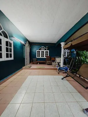 a living room with blue walls and a tile floor at Homestay Bendang Becah in Baling