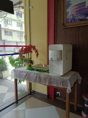 a microwave sitting on a table next to a window at Casavilla Hotel in Taiping