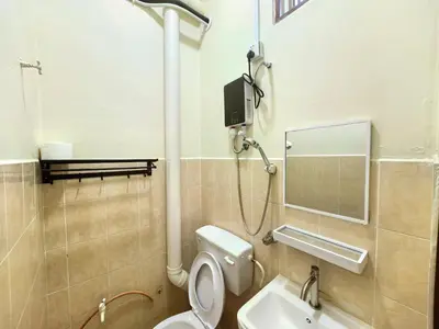 a bathroom with a toilet and a sink at Padang Serai Premier Home in Kampong Dekeh