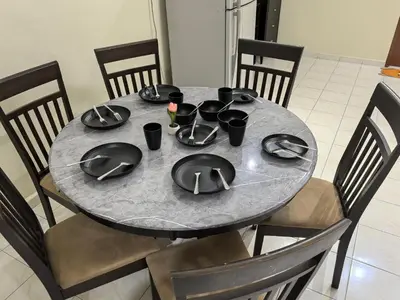 a gray table with black plates and bowls on it at Padang Serai Premier Home in Kampong Dekeh