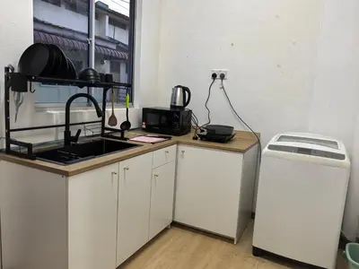 a kitchen with a sink and a counter top at Padang Serai Premier Home in Kampong Dekeh