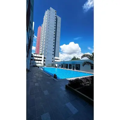 a swimming pool in front of a tall building at Ipoh Anderson Khan Residence by Khan in Ipoh