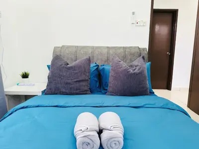 a blue bed with two rolled towels on it at BM\u5927\u5c71\u811a Alma Single Storey Semi-D 5-minute To Aeon Mall in Bukit Mertajam