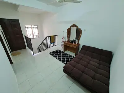 a living room with a couch and a mirror at Azam Homestay in Seri Manjung