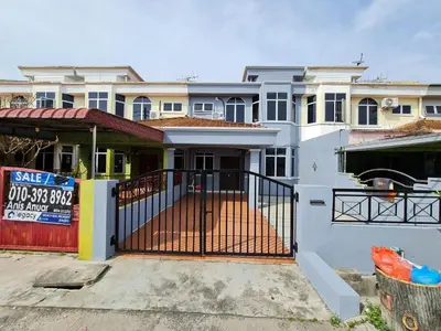 a house with a gate in front of it at Azam Homestay in Seri Manjung