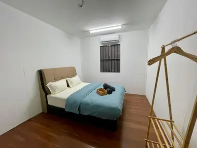 a small bedroom with a bed and a window at Kek Lok Si Inn in Ayer Itam