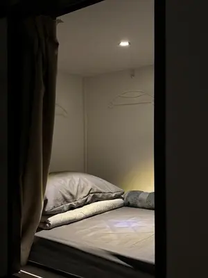 a bed in a small room with a window at Kek Lok Si Inn in Ayer Itam